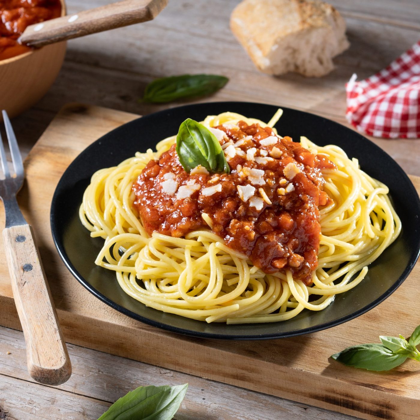 Spaghetti with bolognese sauce on wooden table